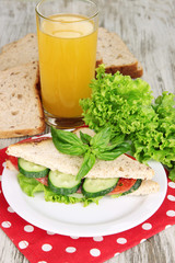 Composition with fruit juice and tasty sandwich with salami