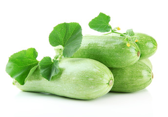 Raw zucchini with leaves, isolated on white