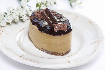 Cappuccino cake on white plate. Selective focus