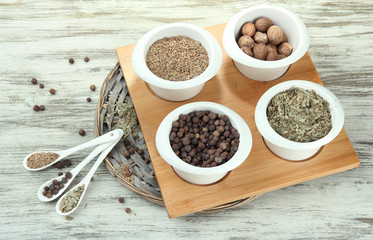 Assortment of spices in  white spoons and bowls,