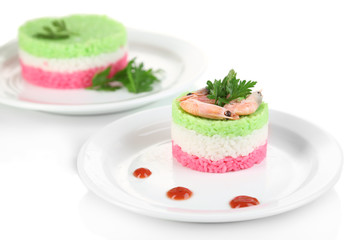Colored rice on plates isolated on white