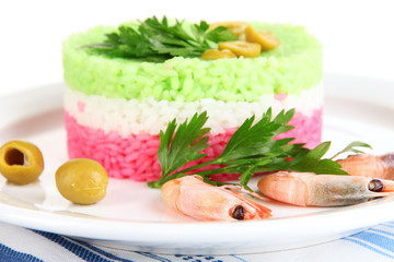 Colored rice on plate on napkin isolated on white