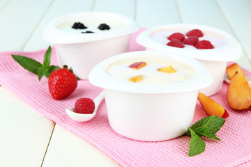 Delicious yogurt with fruit and berries on table close-up