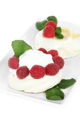 Tasty meringue cakes with berries, isolated on white