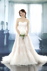 Fototapeta premium young and beautiful bridge in dress in studio