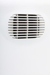 plastic air vent in white wall ventilation grille