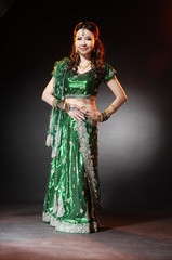 l female wearing traditional indian costume posing in studio