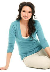 A young woman sitting on the floor, isolated on white