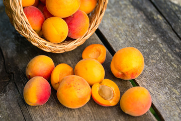 apricots in a basket on wooden background