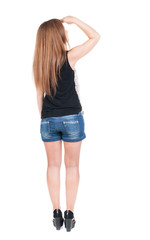 back view of standing young beautiful  redhead woman.