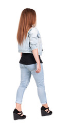 back view of walking  woman.