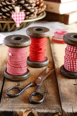 Decoration with wooden spools and red ribbons