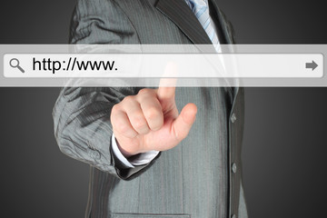 Businessman pushing virtual search bar on dark background