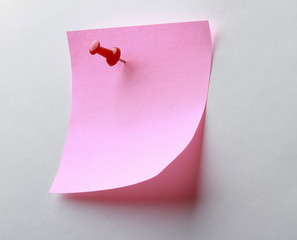 Pink paper note on white background isolated.