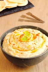 Chickpea hummus with olive oil and paprika and pita bread