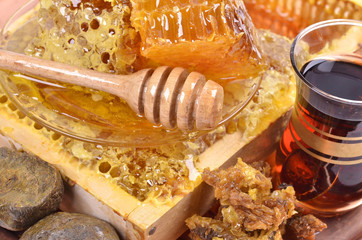 fresh  honeycombs  and wooden stick ,cup of Turkish tea