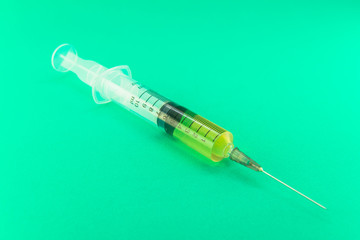 Syringe with a medicine in a female hand