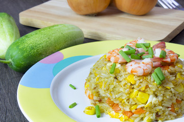 Fried rice with shrimp on the wood table
