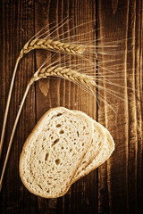 Fototapeta na wymiar Bread slices, wheat ears and grains