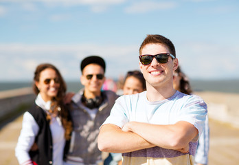 teenager in shades outside with friends