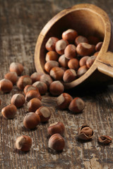 Hazelnuts  in a laddle and on wooden background