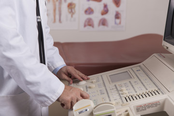 A medical professional uses an ultrasound machine in a doctors o