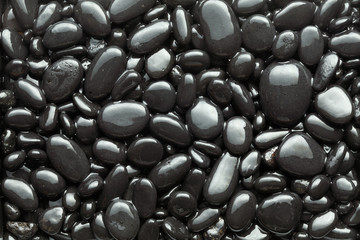 Black wet pebble as a background