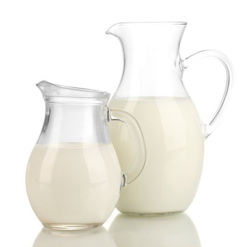 Milk in jugs isolated on white