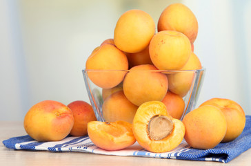 Fresh natural apricot in bowl on table in kitchen