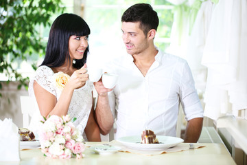 Beautiful young romantic couple at cafe