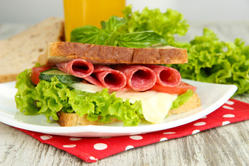 Composition with fruit juice and tasty sandwich with salami