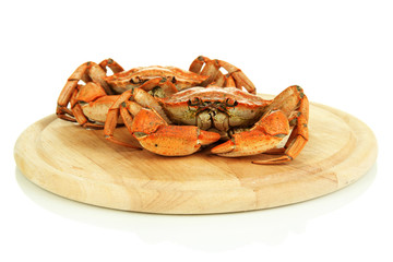 Boiled crabs on wooden board, isolated on white