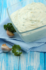 Sour cream in bowl on table close-up