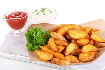 Home potatoes on tracing paper on wooden board isolated on