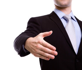 Portrait of young business man extending hand to shake against w