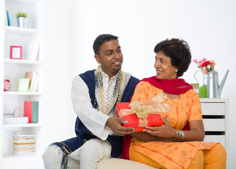 indian son giving present to his mother