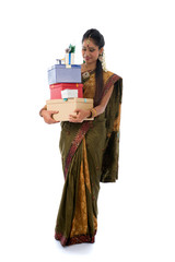 Fototapeta premium Portrait of a woman in traditional saree holding gifts and smili