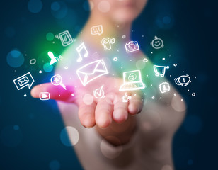 Young woman presenting colorful social media icons