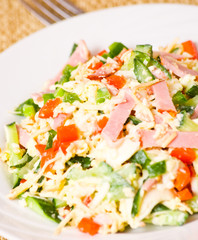 fresh salad with cheese, ham and vegetables