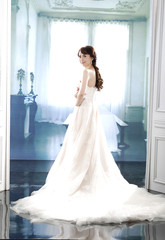 young and beautiful bridge in dress holding bouquet flower