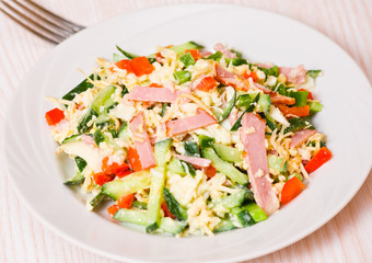 Fototapeta na wymiar fresh salad with cheese, ham and vegetables