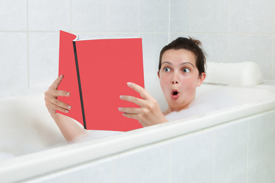 Young Woman In Bathtub Reading Book