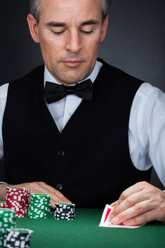 Human hand of poker player with cards and chips