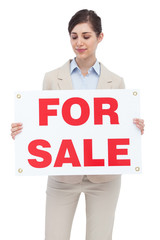 Estate agent holding for sale sign