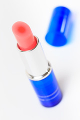 Isolated of a pink lipstick with blue tube on white