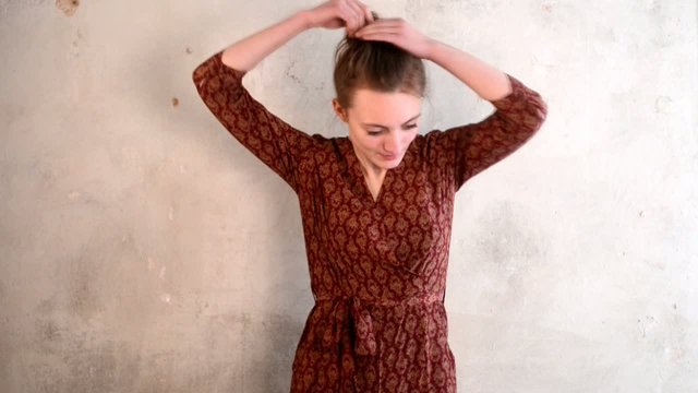 Young woman opening her hairs, indoor studio footage