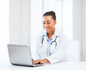 female doctor with laptop pc