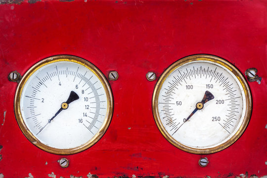 Old red industry panel with two analog meters