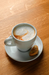 cappuccino cup on wooden table