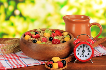 Oatmeal with fruits on table on bright background